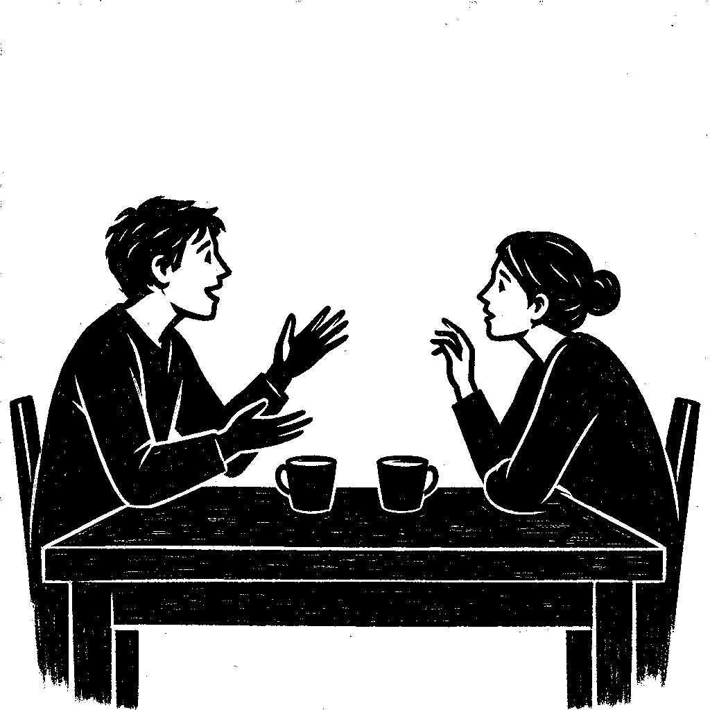 Two people at a kitchen table with cups between them; one talks with a hand gesture and the other leans forward, listening.